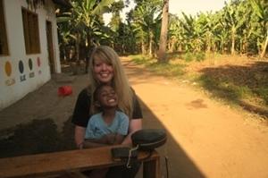 Gap Year volunteer playing with a child on a Care project Volunteer and child play on the toys outside of a care center on a Care project